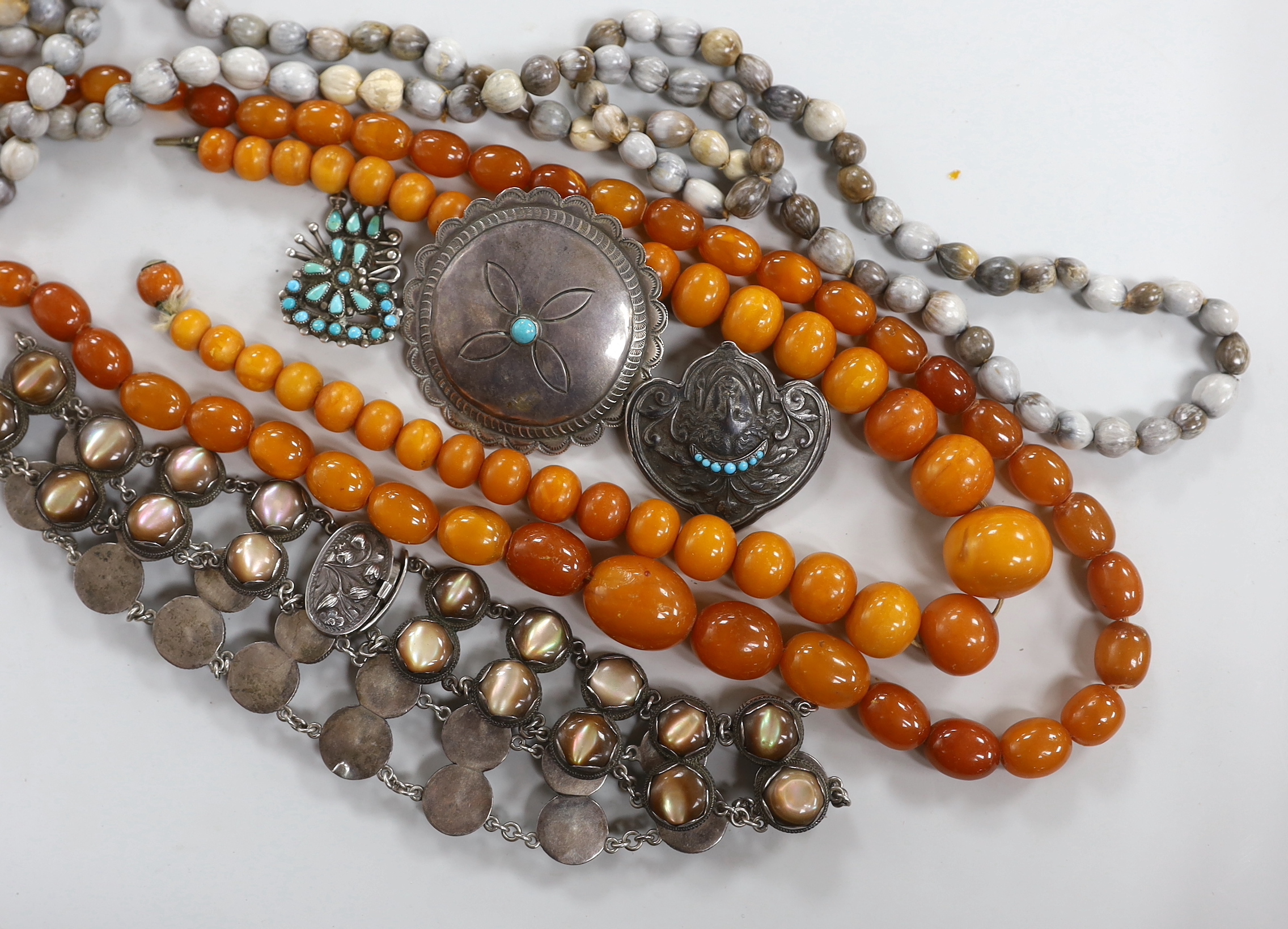 Two graduated amber bead necklaces, 100cm and 41cm, gross weight 116 grams, together with other jewellery including a white metal and mother of pearl set necklace.